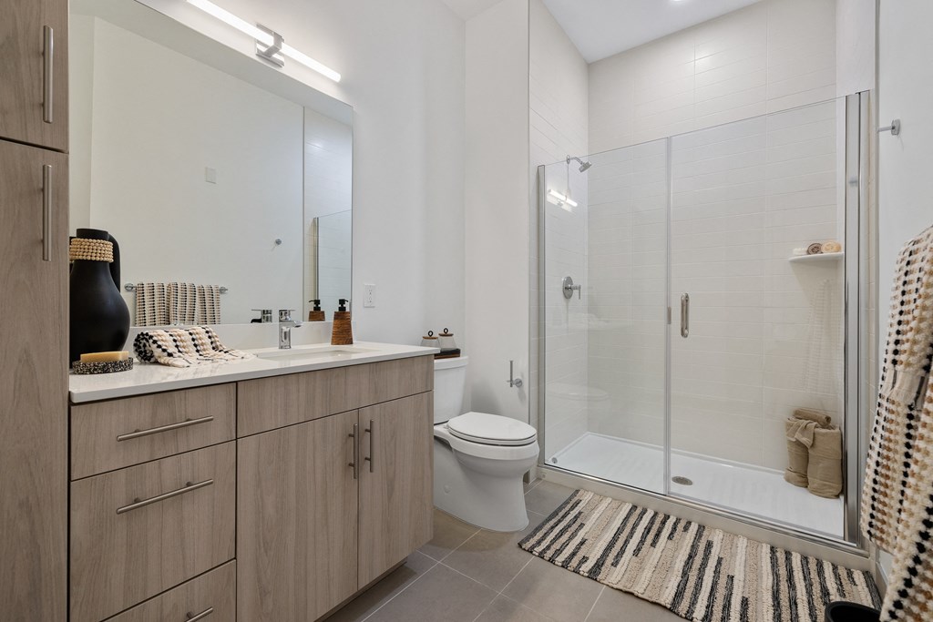 a bathroom with a shower and a sink and a toilet