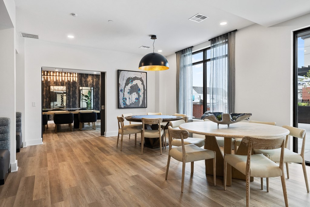 a dining area with tables and chairs and a large window