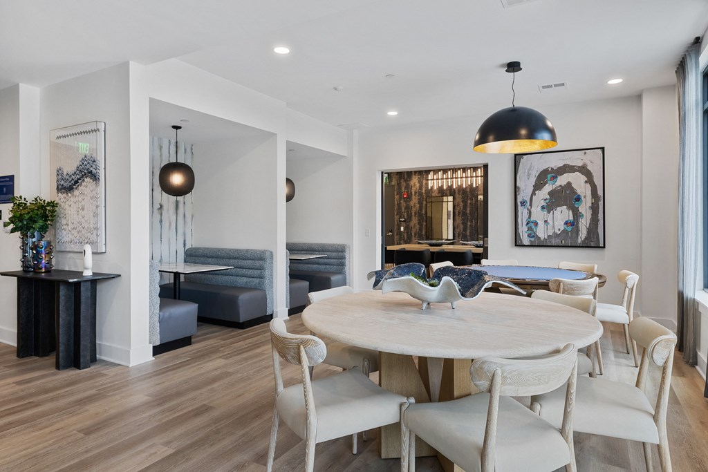a dining area with a table and chairs and a living room with a couch