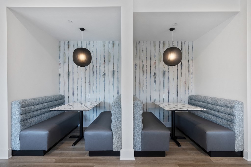 a dining room with two tables and two chairs and two lights