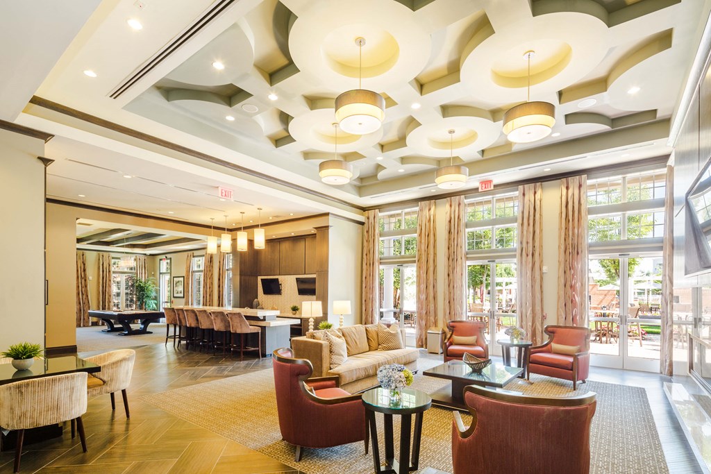 A large, well-lit room with a variety of seating options and a fireplace.