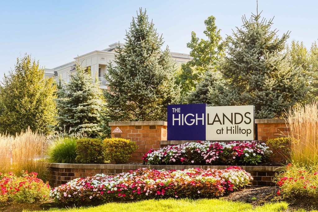 The Highlands at Hilltop sign in front of a building.