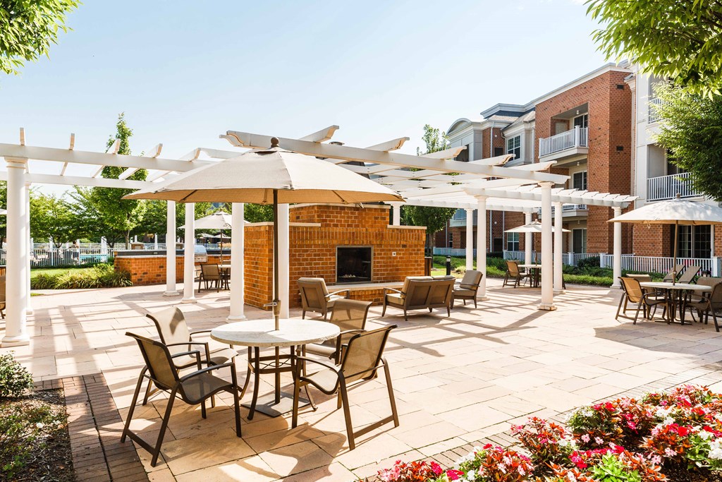 a patio with tables and chairs and umbrellas