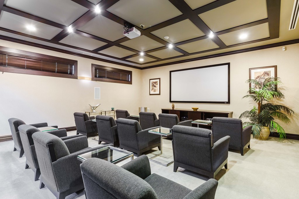 A conference room with a long table and chairs.