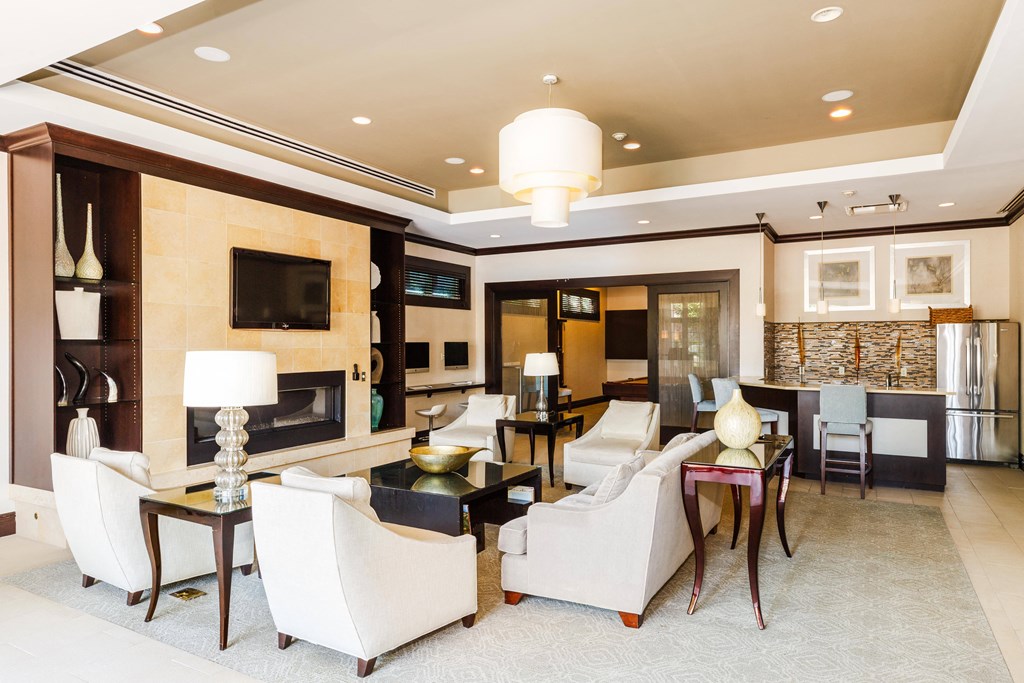 A living room with a fireplace and a television.