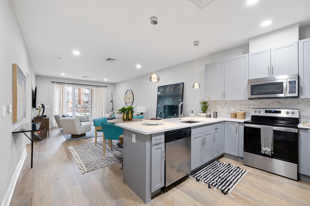 a kitchen with an island and a living room with a dining room