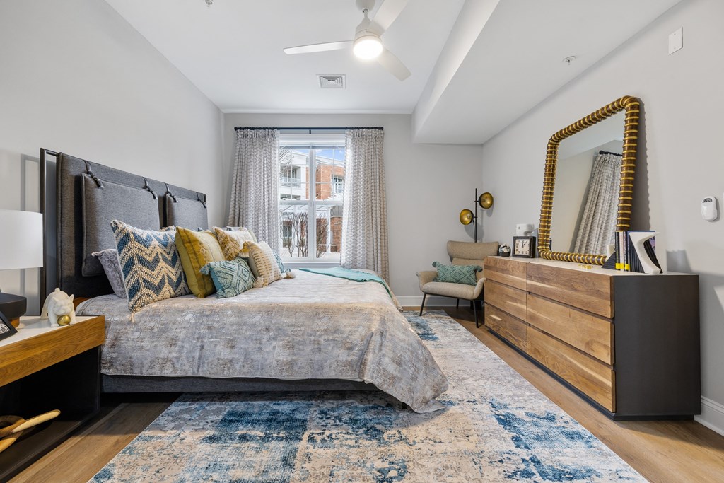 a bedroom with a bed and a dresser and a window