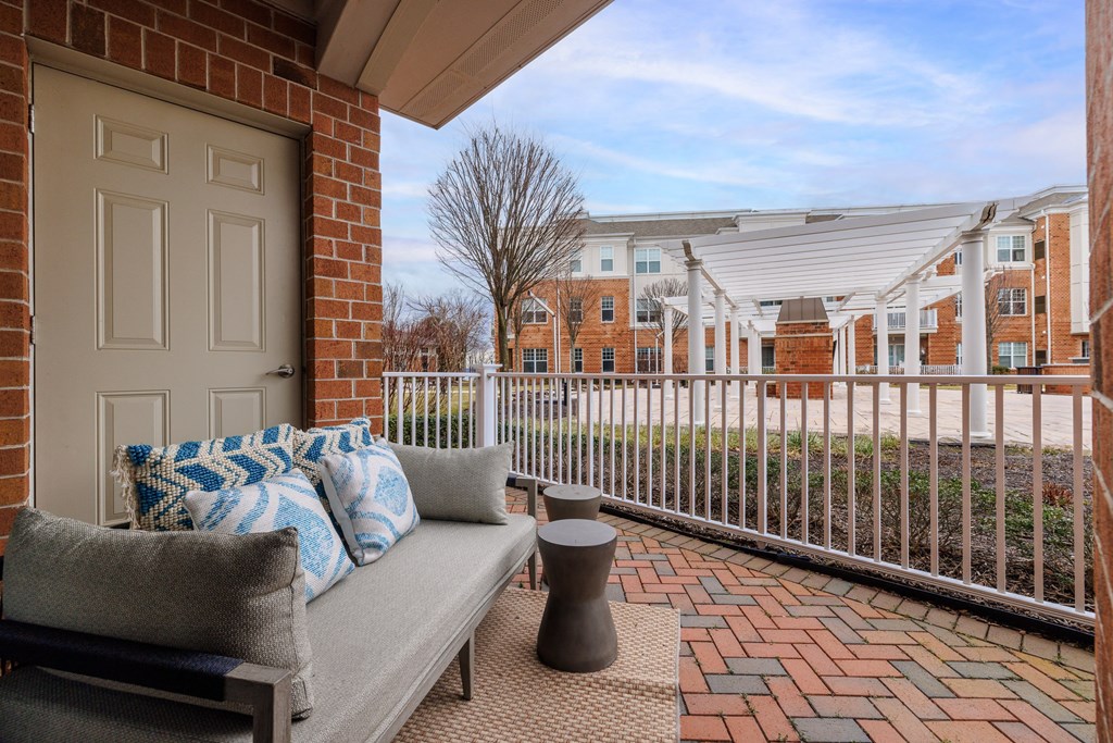 a patio with a couch and a door to a building