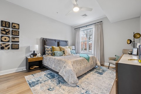 Bedroom with upholstered headboard and decorative pillows at Highlands at Hilltop Apartments, Verona, New Jersey
