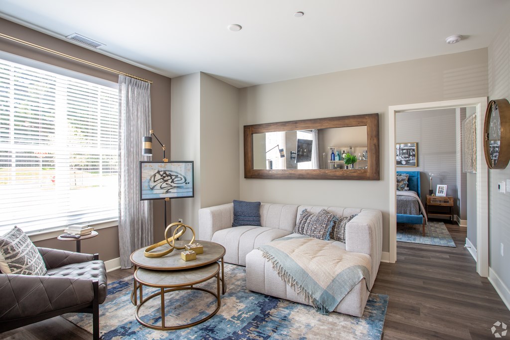 A living room with a white couch and a coffee table.