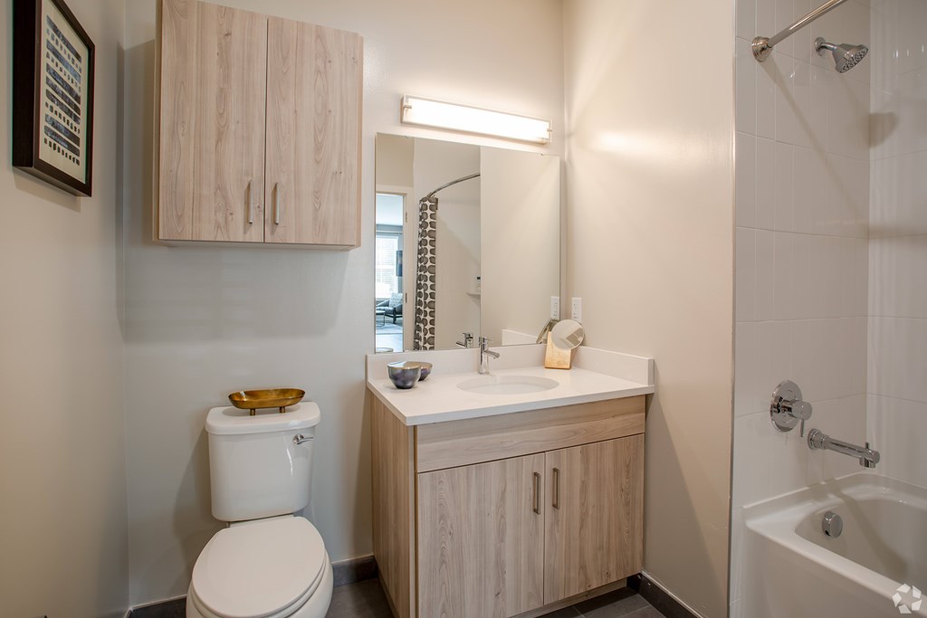 A white toilet sits next to a sink in a small bathroom.