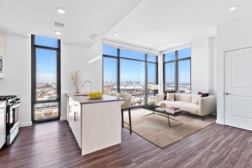 an open living room with a kitchen and a view of the city