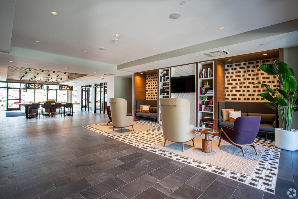 A spacious living room with a fireplace and a bookshelf.