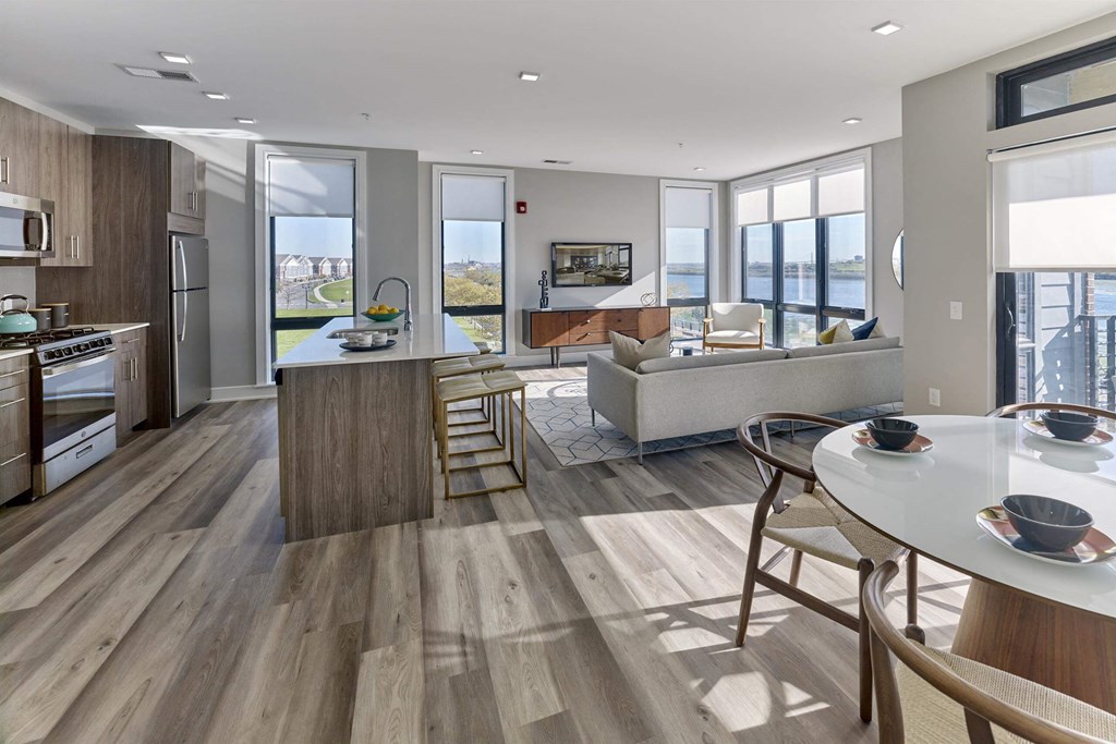 A modern kitchen with a dining table and chairs.