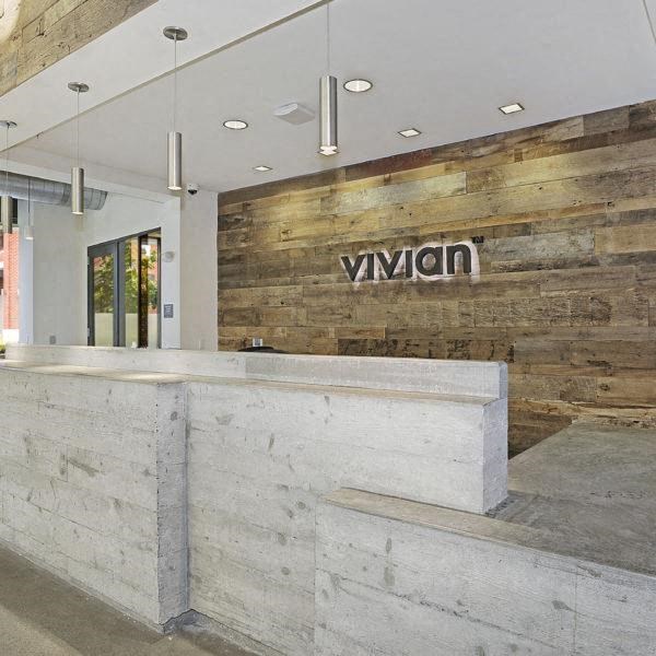 a lobby with a reception desk and a sign