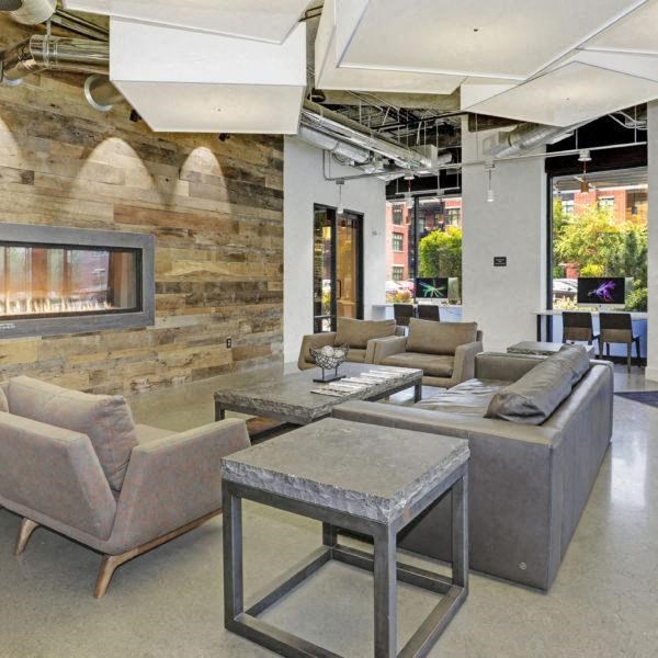 a living room with couches and tables and a fireplace