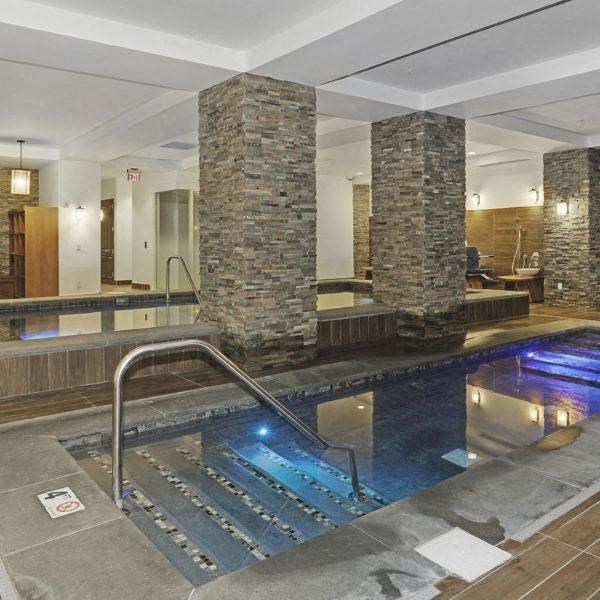 a swimming pool with a water feature in the middle