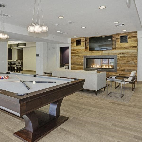 a game room with a pool table and a fireplace