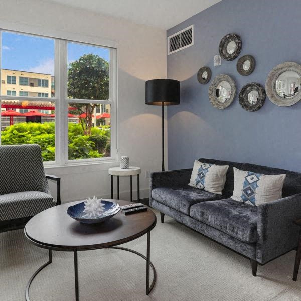 a living room with a couch and a table and a window