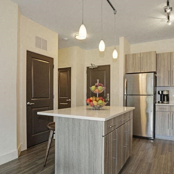 a kitchen with a large island and a refrigerator