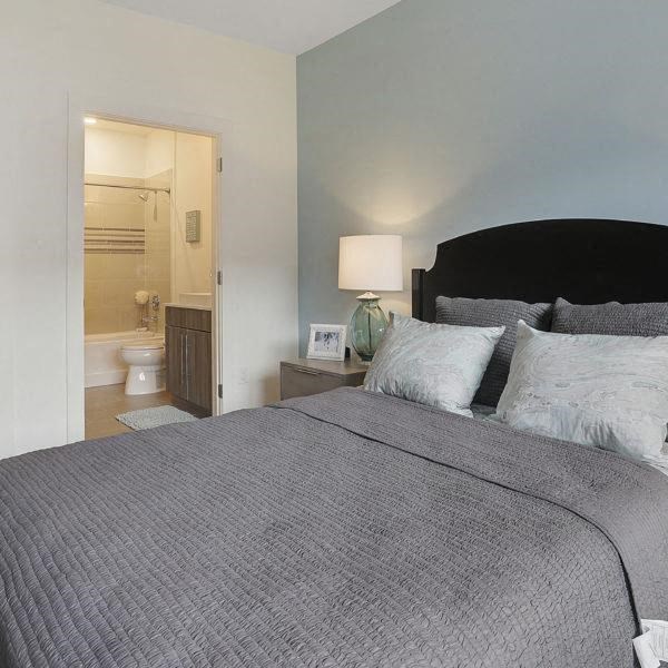 a bedroom with a large bed and a bathroom