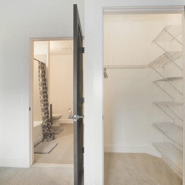 a bathroom with a shower and a toilet and a glass door