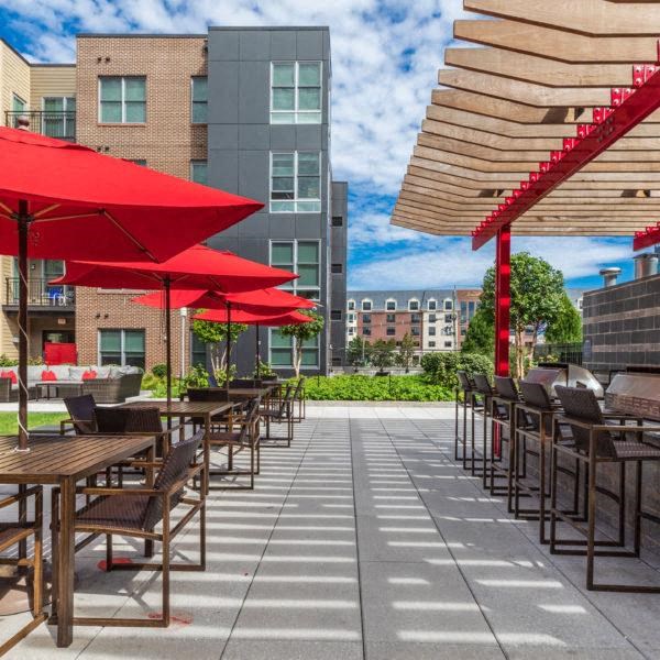 an outdoor patio with tables and umbrellas