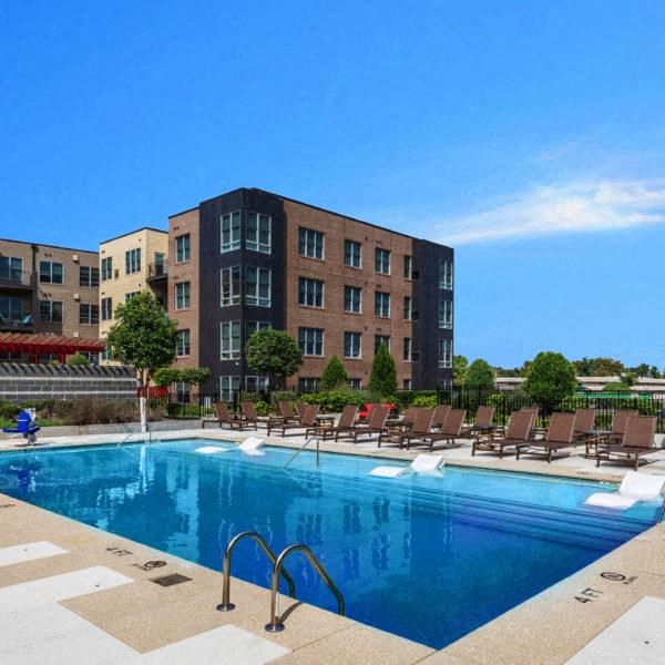 a swimming pool with a building in the background