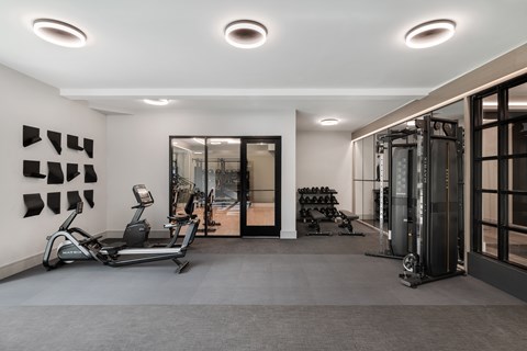 A gym with treadmills, weights, and exercise equipment.