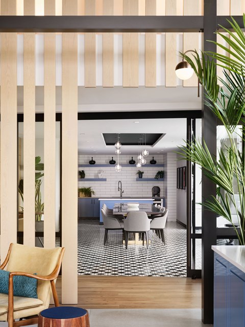 A modern kitchen with a dining table and chairs.