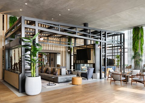 A modern living room with a large grey sofa and a wooden coffee table.
