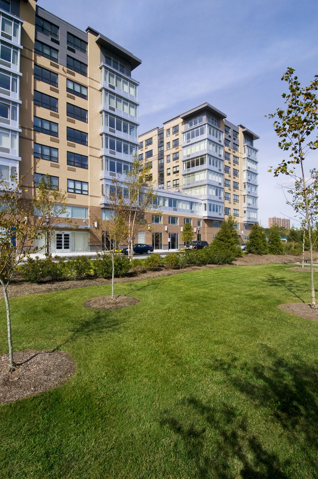 a park in front of apartment buildings on a sunny day