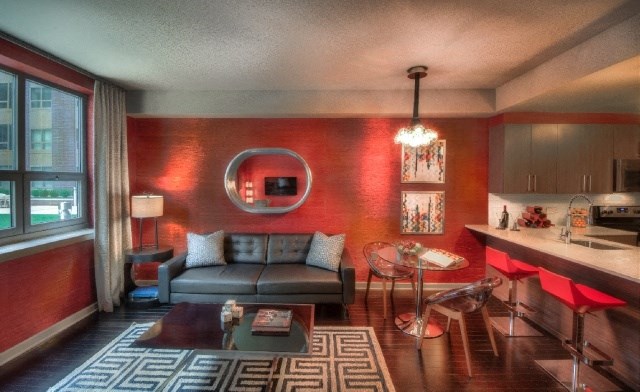 a living room with a couch and a kitchen with a table and chairs