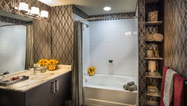 a bathroom with a shower and a sink and a bath tub