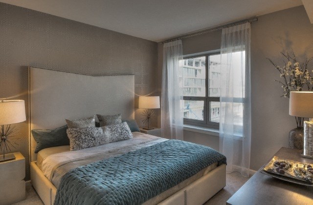 a bedroom with a bed and a large window