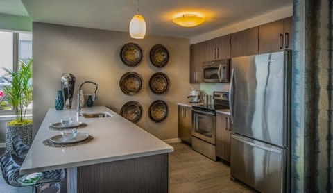 a kitchen with stainless steel appliances and a white counter top
