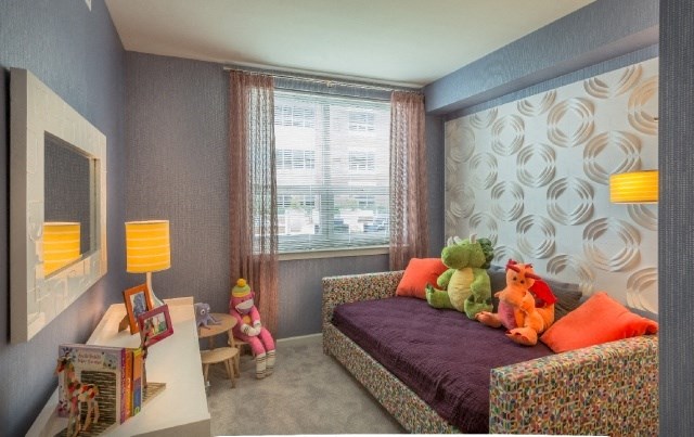 a childs bedroom with a bed and stuffed animals on it