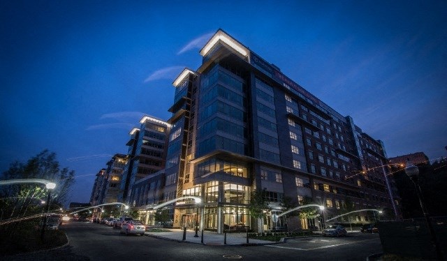a tall building at night on a city street