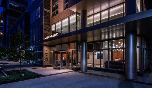 a night view of the front of a building with a glass door
