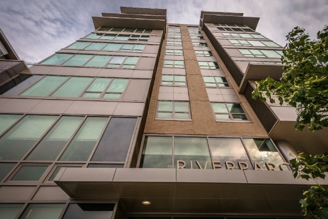 A modern building with the name Riverpark on the facade.