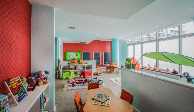 a living room filled with toys and a table and chairs