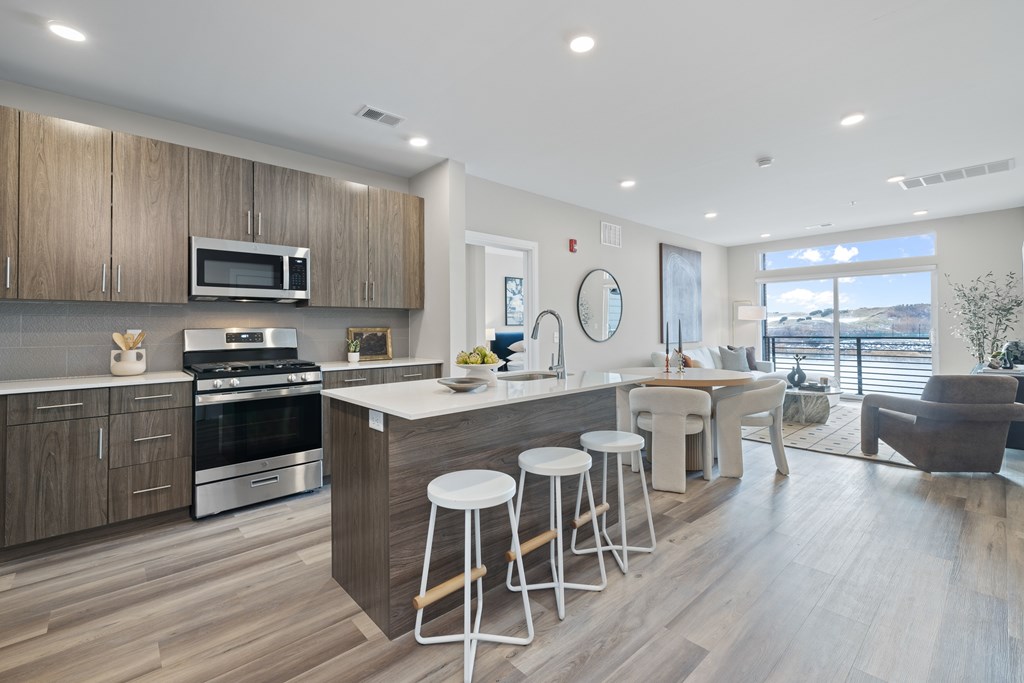 A modern kitchen with a bar stool and a countertop.
