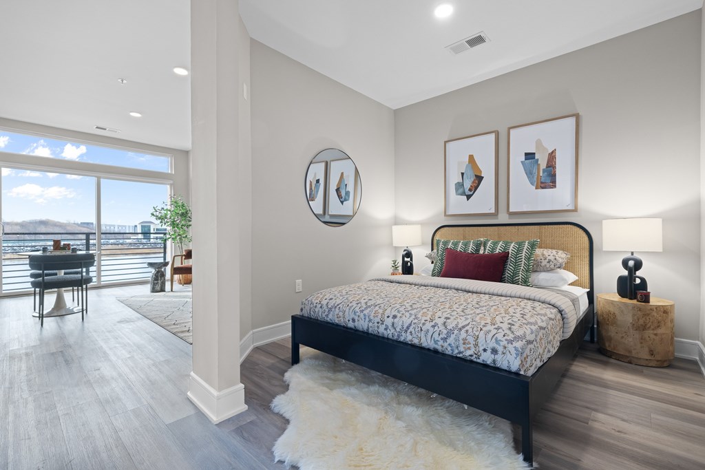A bedroom with a large bed and a view of the ocean.