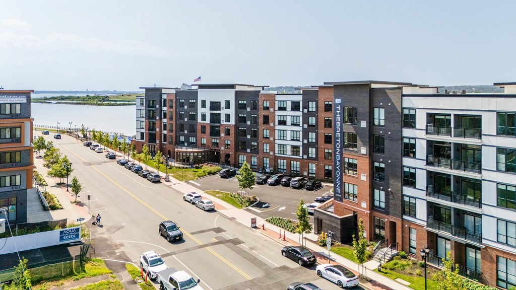A street view of a city with cars and buildings.