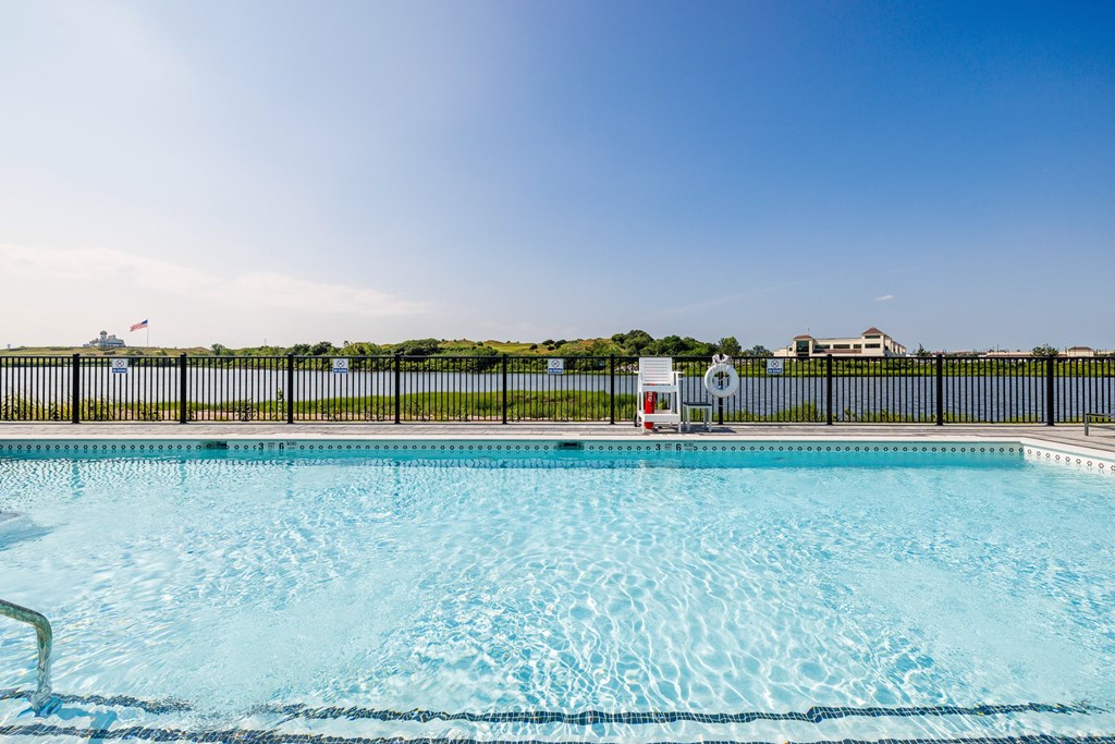A swimming pool with a blue sky in the background.