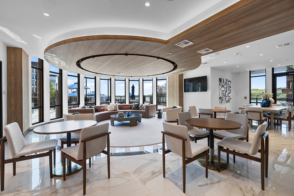 A modern dining room with a large table and chairs.