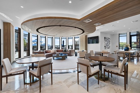 A modern dining room with a large table and chairs.