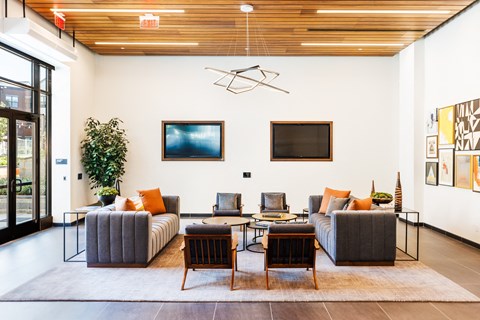 A living room with a grey couch and a wooden table.