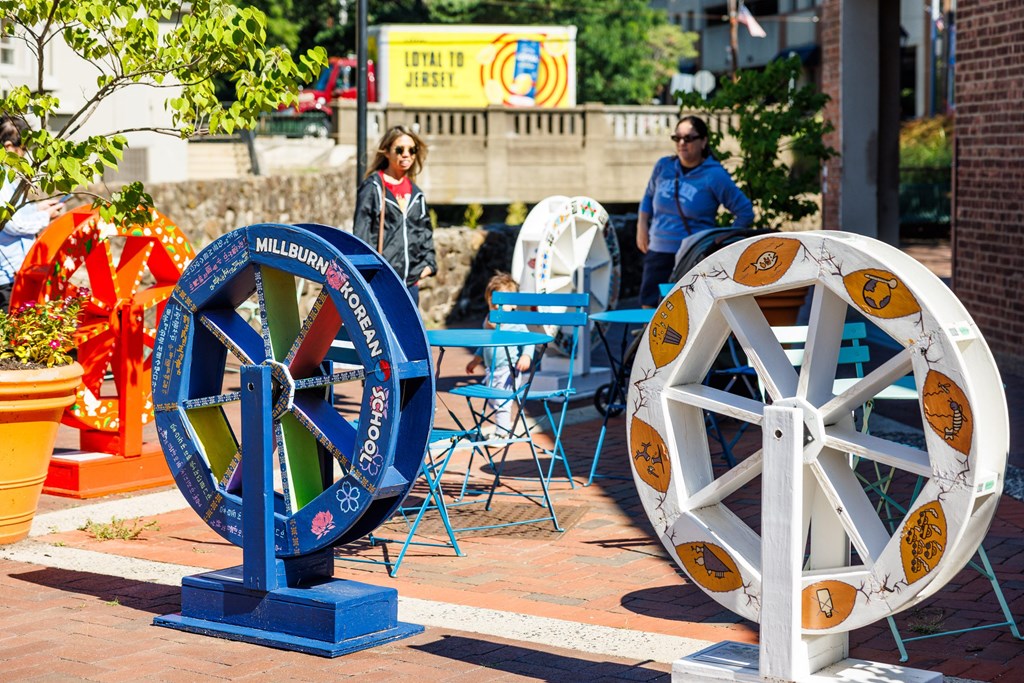 A blue and white wheel is on display in front of a red truck.