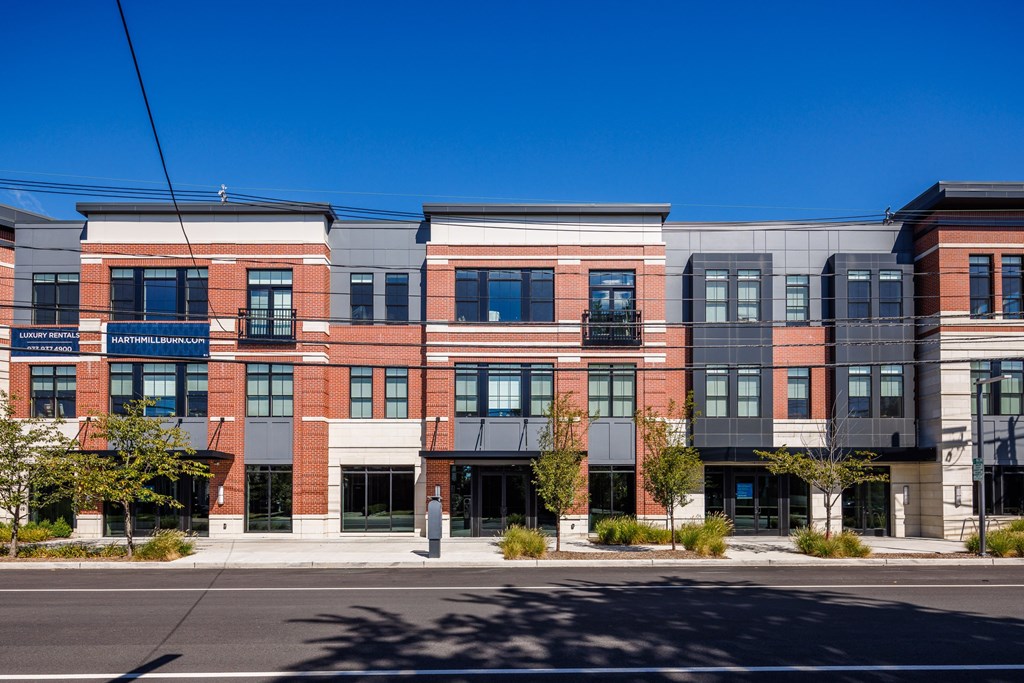 A row of modern buildings with a clear blue sky above.